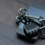 Smartphone wrapped in a chain and padlock symbolizing data privacy protection