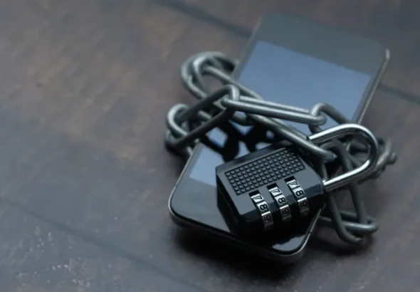 Smartphone wrapped in a chain and padlock symbolizing data privacy protection