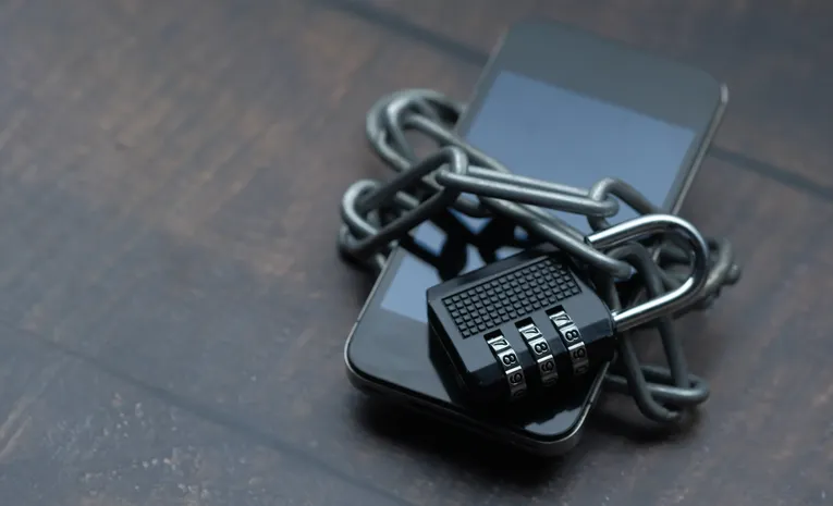 Smartphone wrapped in a chain and padlock symbolizing data privacy protection