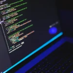 Laptop screen showing code in a dark terminal environment for running local AI models