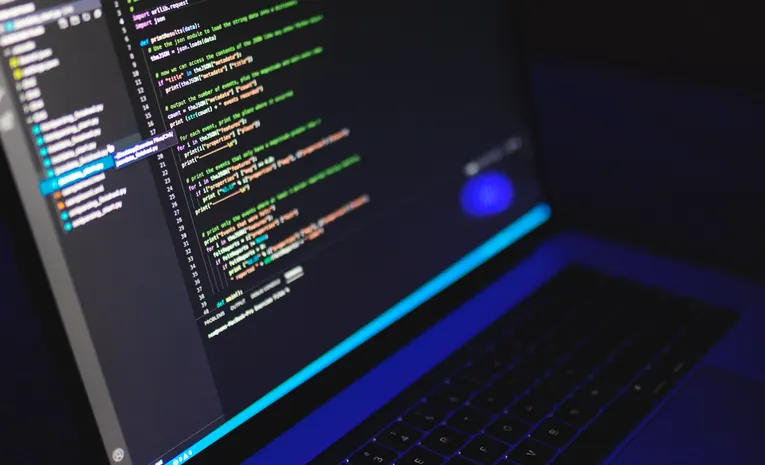 Laptop screen showing code in a dark terminal environment for running local AI models