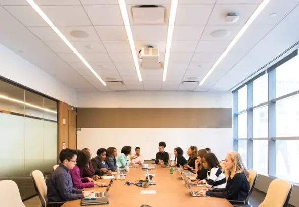Group of professionals in a conference room meeting representing AI meeting note takers