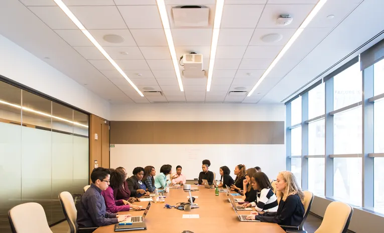 Group of professionals in a conference room meeting representing AI meeting note takers