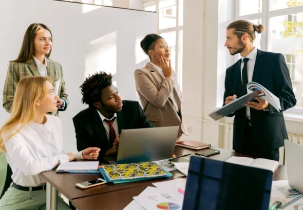 Diverse group of business professionals collaborating in a modern office meeting