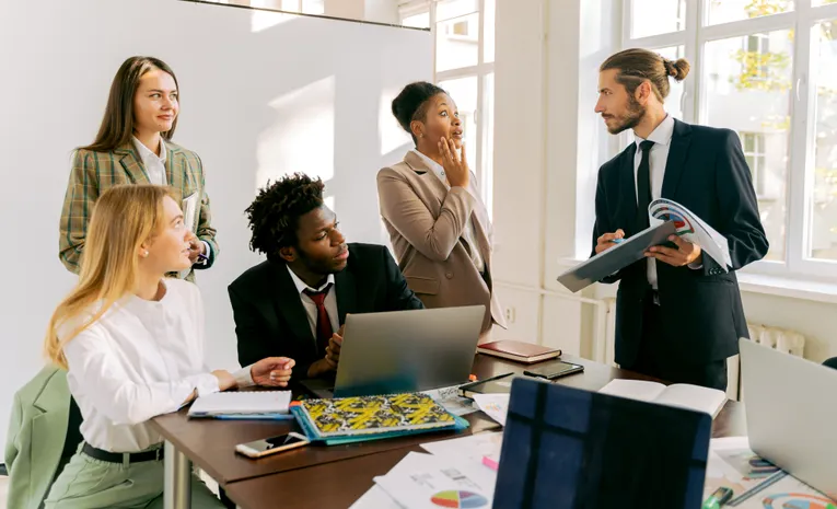 Diverse group of business professionals collaborating in a modern office meeting