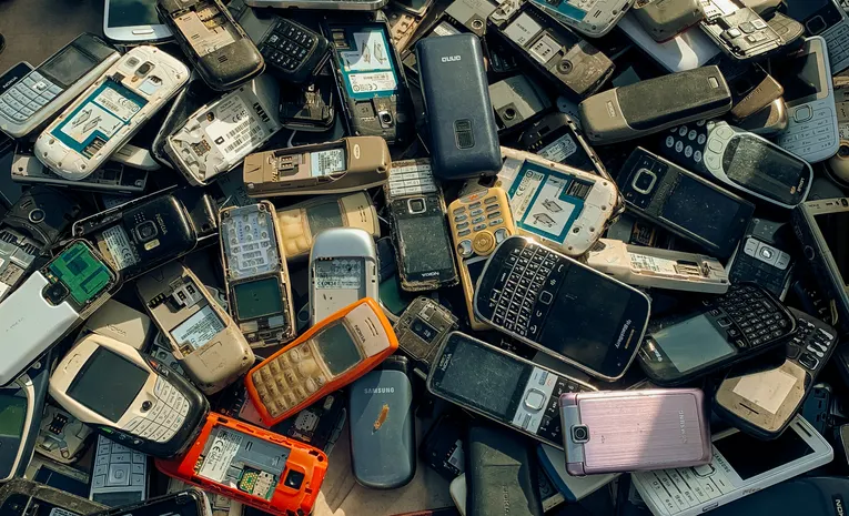 Pile of old mobile phones stacked for electronic waste recycling