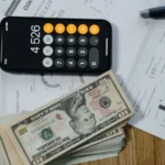 Calculator and financial documents on a desk representing UK invoicing software