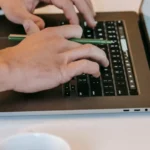 Freelancer working on a laptop at a desk representing productivity tools for UK freelancers
