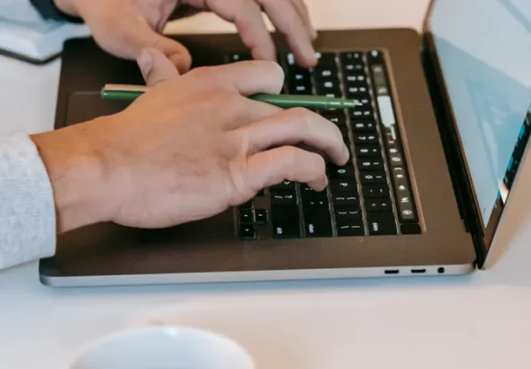 Freelancer working on a laptop at a desk representing productivity tools for UK freelancers