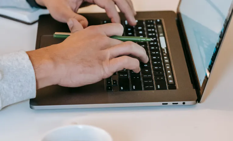 Freelancer working on a laptop at a desk representing productivity tools for UK freelancers