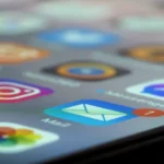 Close-up of smartphone screen showing multiple app icons representing SaaS sprawl