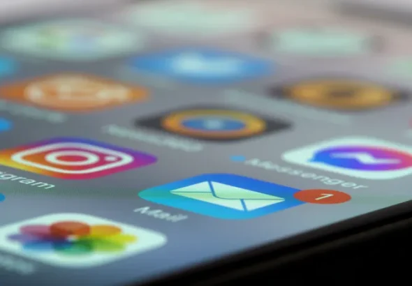 Close-up of smartphone screen showing multiple app icons representing SaaS sprawl