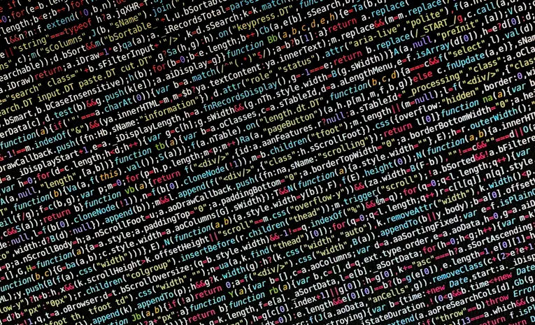 Colorful programming code on a screen representing software complexity and bloat