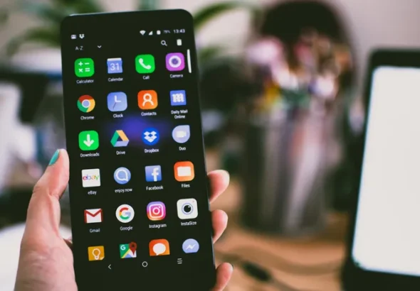Smartphone showing app icons on a home screen representing app interface redesigns