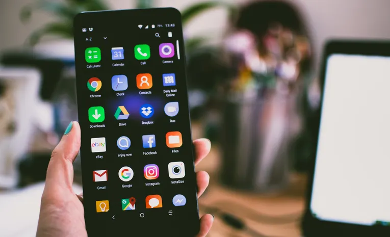 Smartphone showing app icons on a home screen representing app interface redesigns